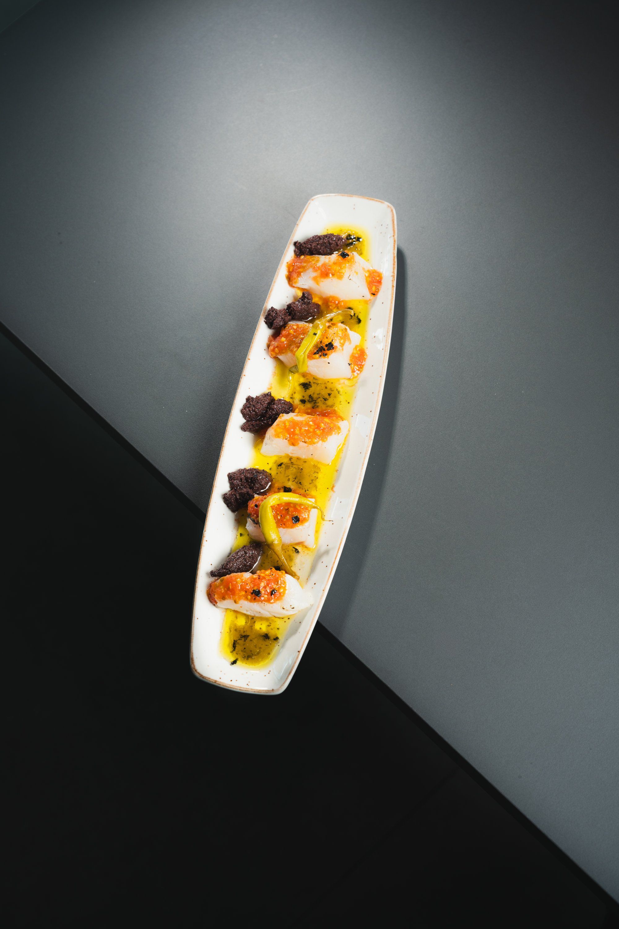 Tempered cod loin bites with tomato pulp and red piparra coulis